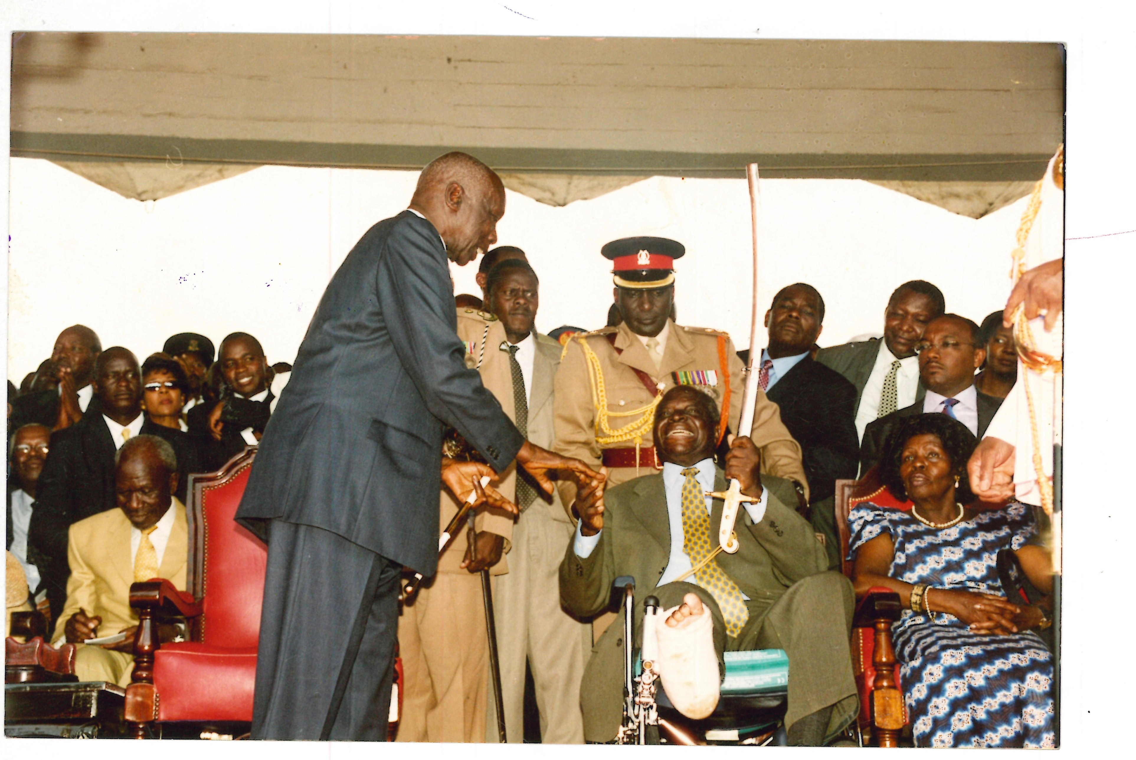 President Mwai Kibaki Receiving the sword from outgoing President Daniel Arap Moi during the inauguration of the Third President at Uhuru Park