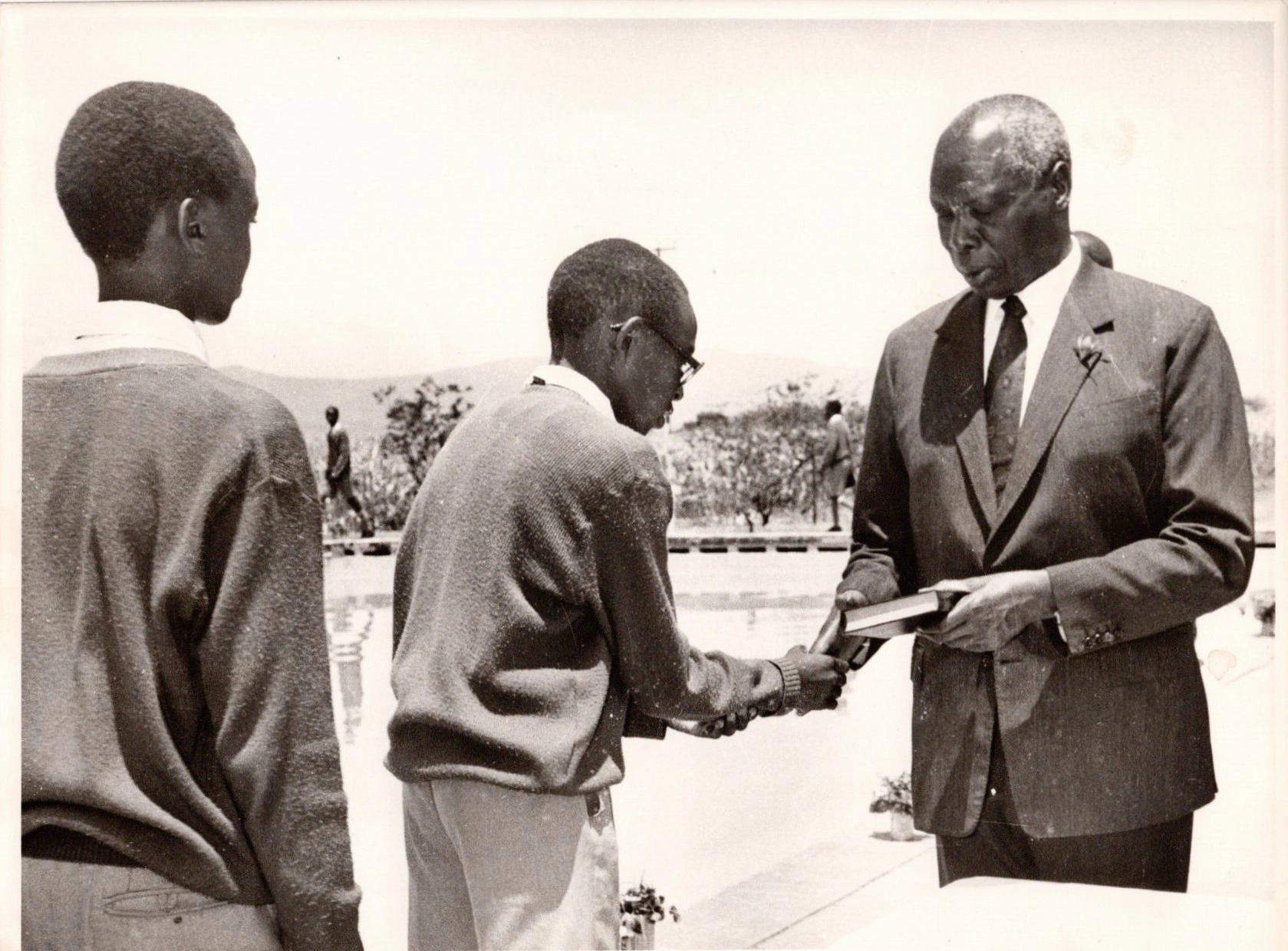 President Daniel Arap Moi Presents a Bible to one of the students of Moi High School Kabarak during the baptismal worship led by Rev Johnes Kareri