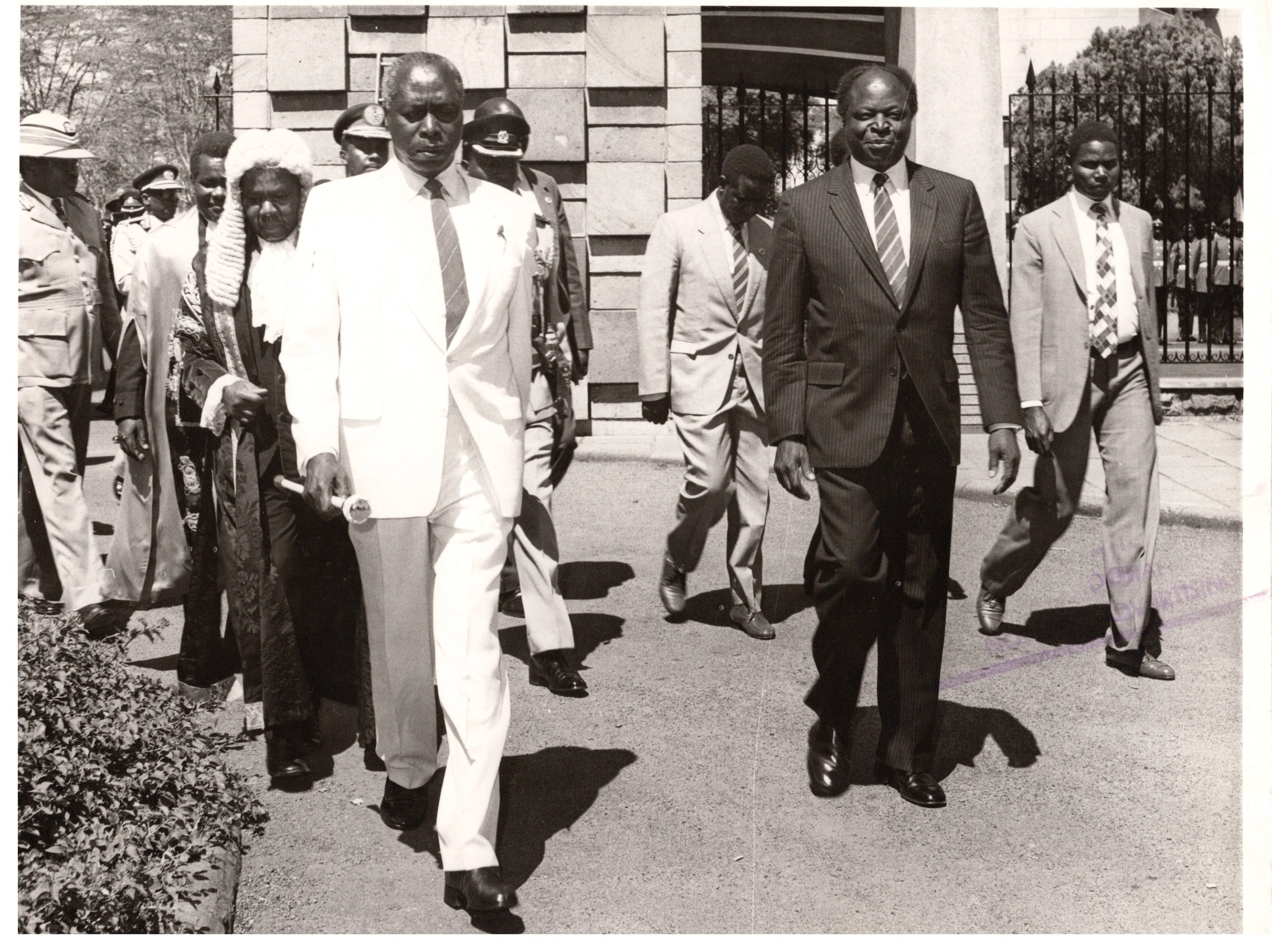 President Daniel Arap Moi arriving at Parliament Buildings being escorted by Speaker Fred Mati and VP Mwai Kibaki during official opening