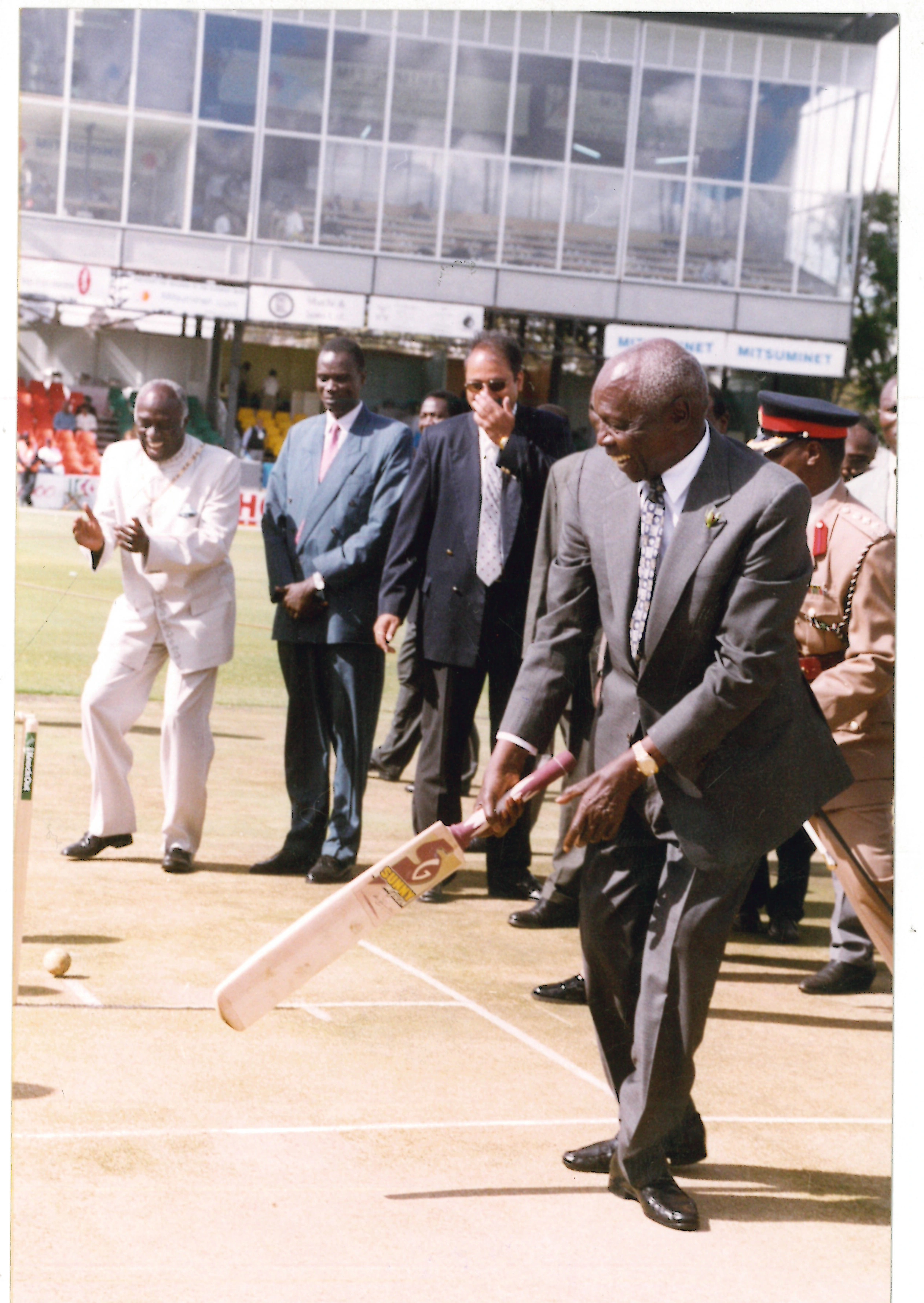 President Daniel Arap Moi tries his hand in cricket as he is cheered by leaders at Gymkhana Club in Nairobi