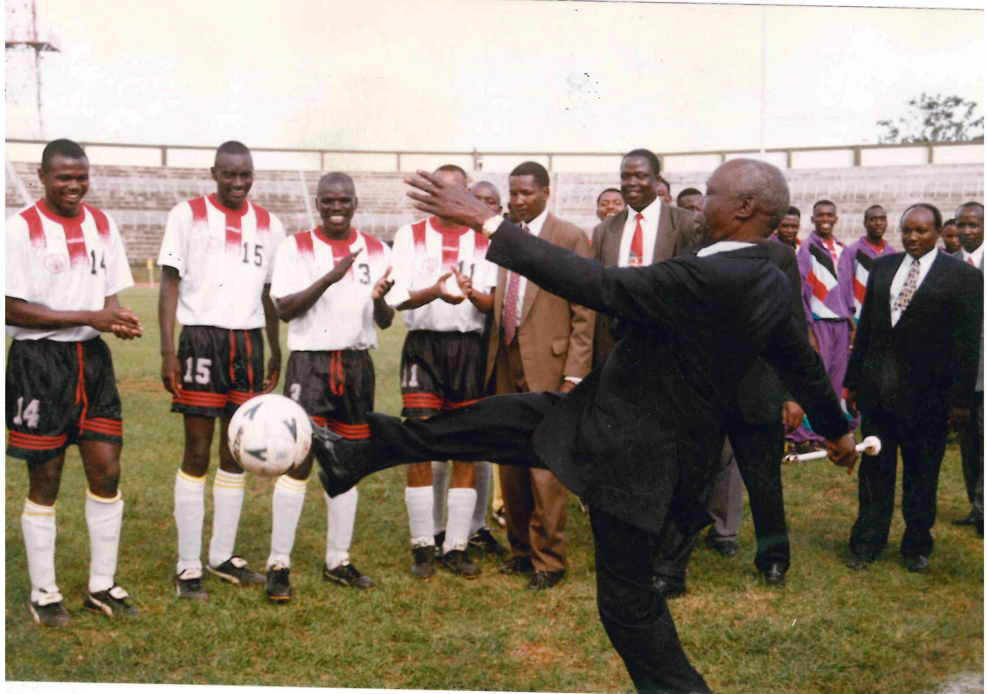 President Daniel Moi entertains footballers and fans with a ball kick during a premier league match between AFC Leopards and Utalii FC at Nyayo Stadium