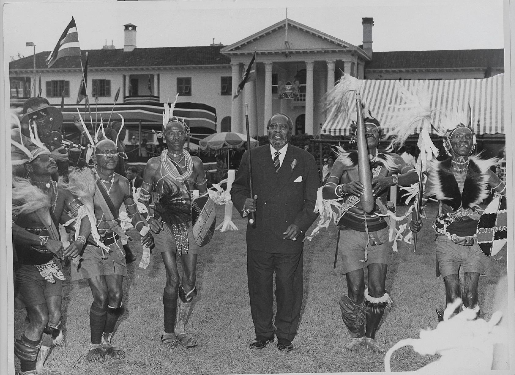 President Jomo Kenyatta being entertained by Kikuyu traditional dancers