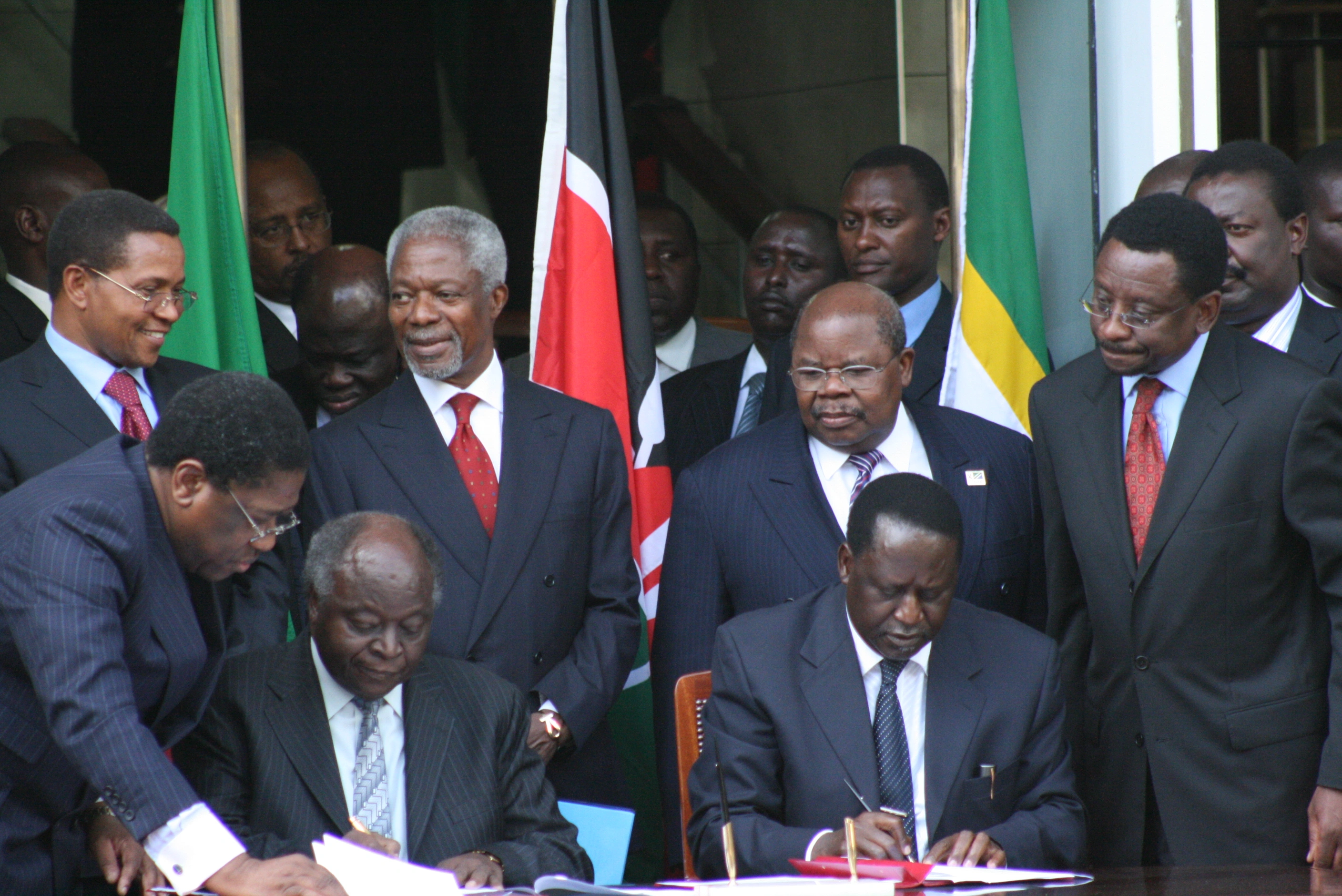 President Mwai Kibaki and opposition leader Raila Odinga signing the Power Sharing Deal at Harambee House Nairobi